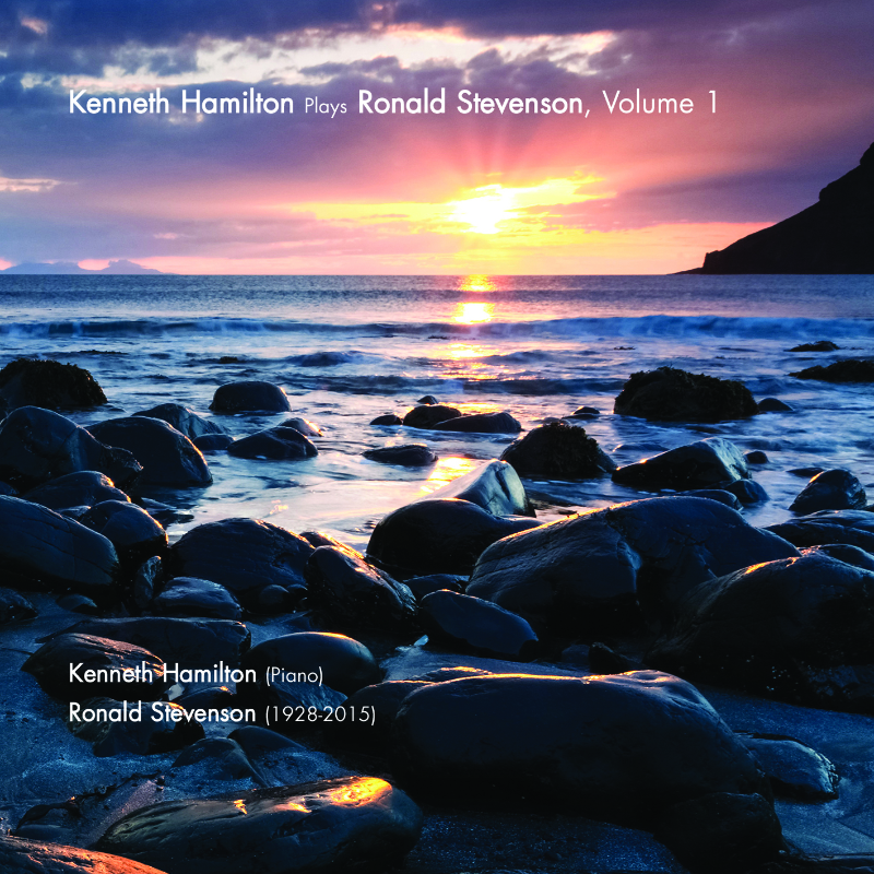 Sunset over a sea with small rocks in the foreground.